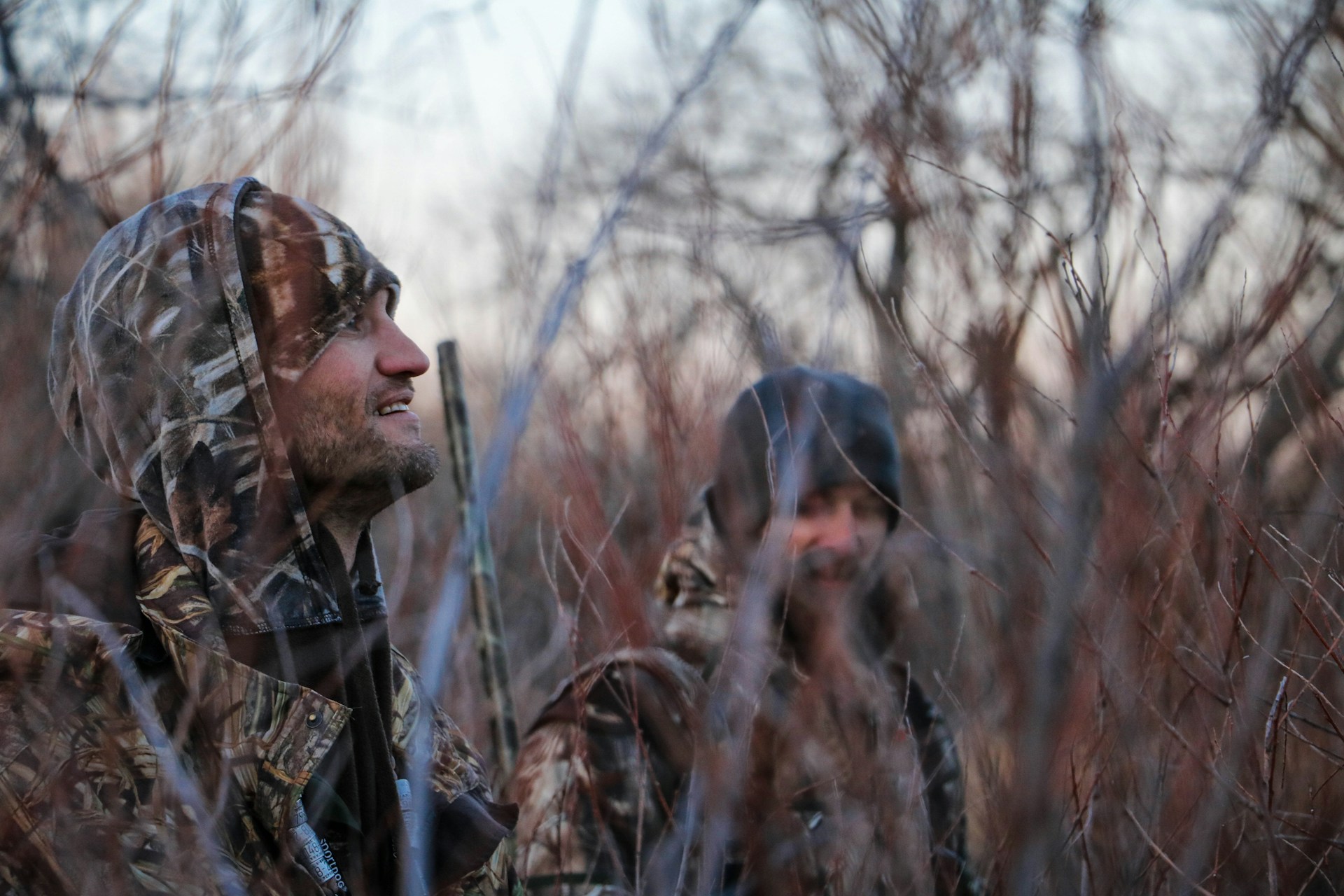 2 men hunting in woods, background image